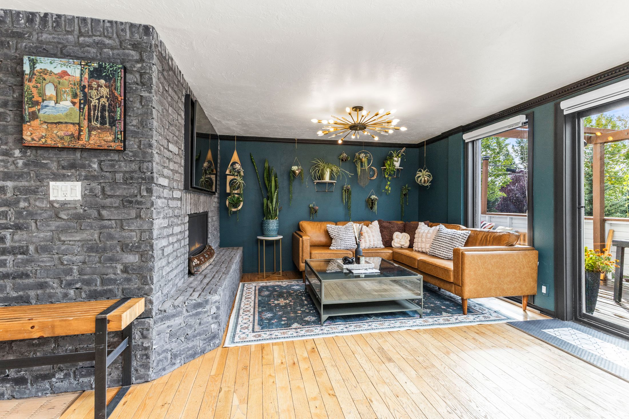 Living room with teal walls and leather sectional