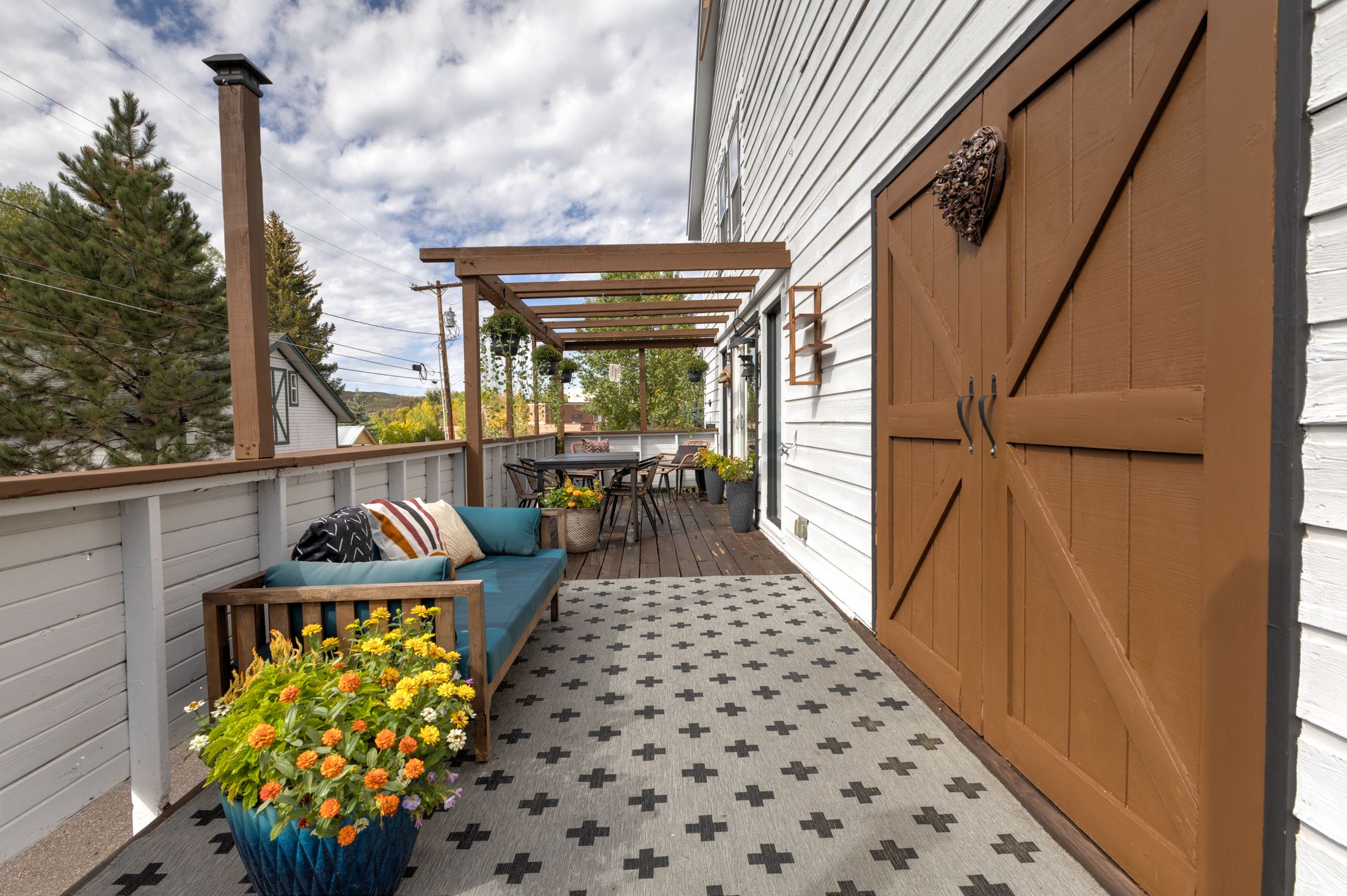 Deck with pergola and barn-style door