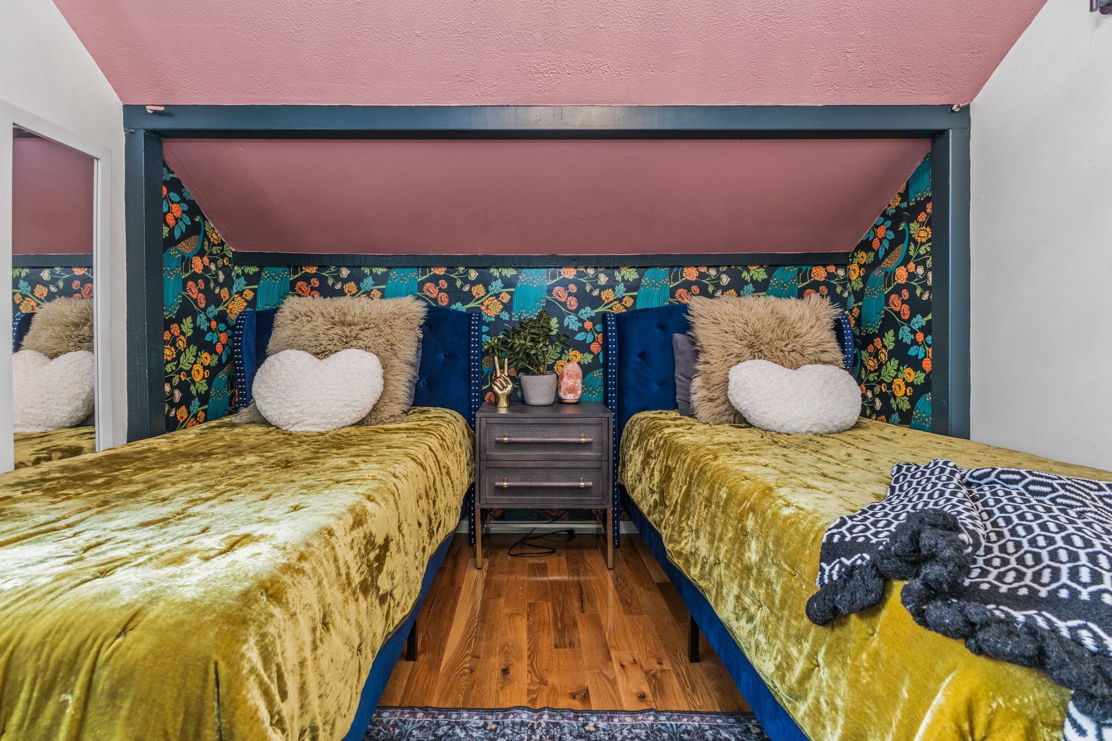 Twin bedroom with floral wallpaper