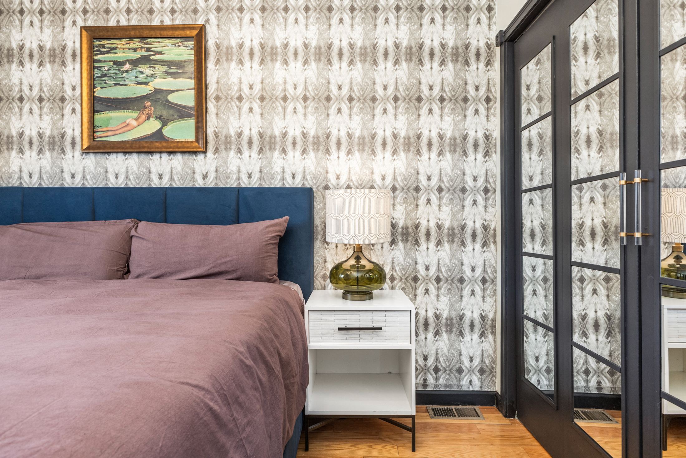 Primary bedroom with lily pad artwork