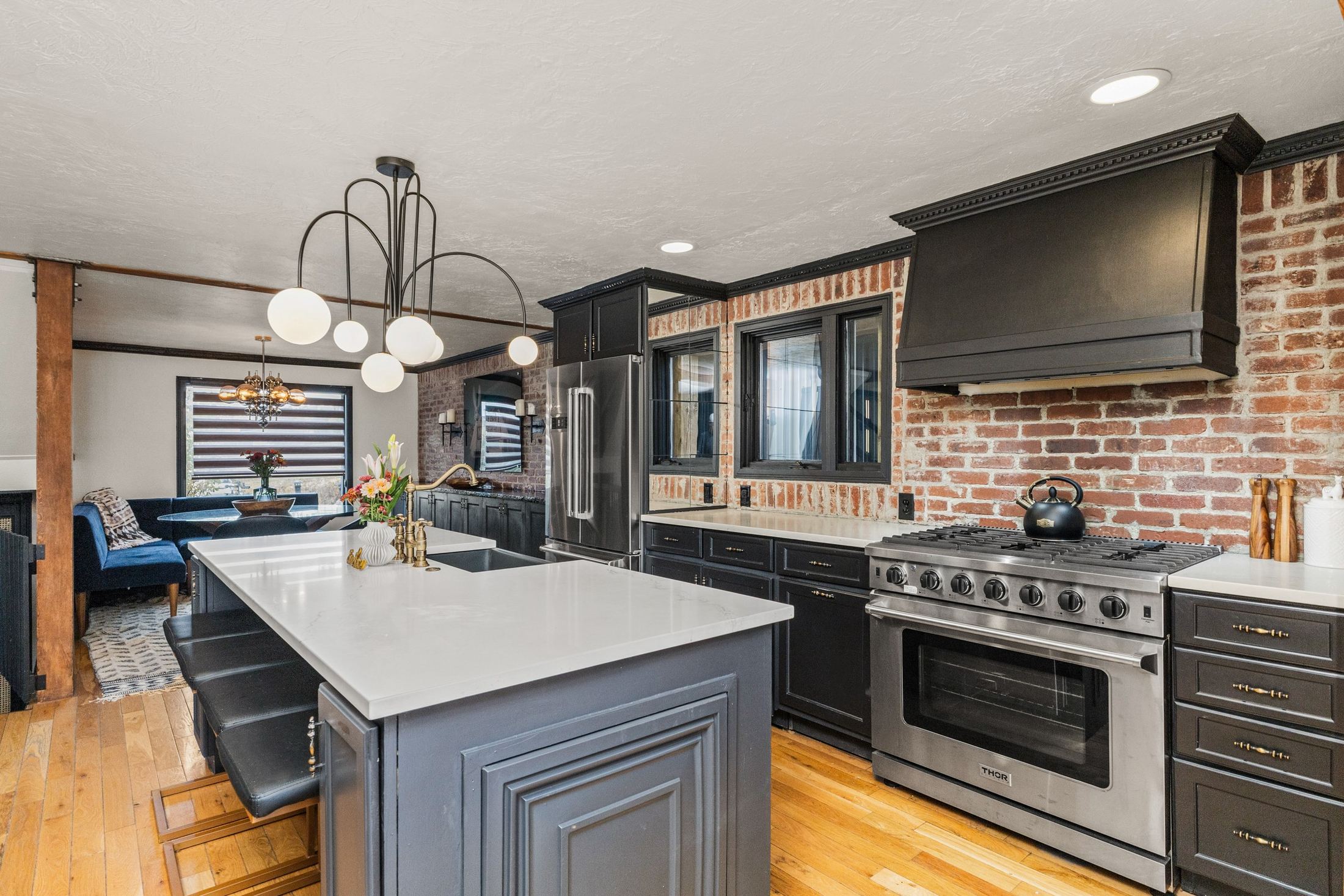 Kitchen with Thor range, island and brick backsplash