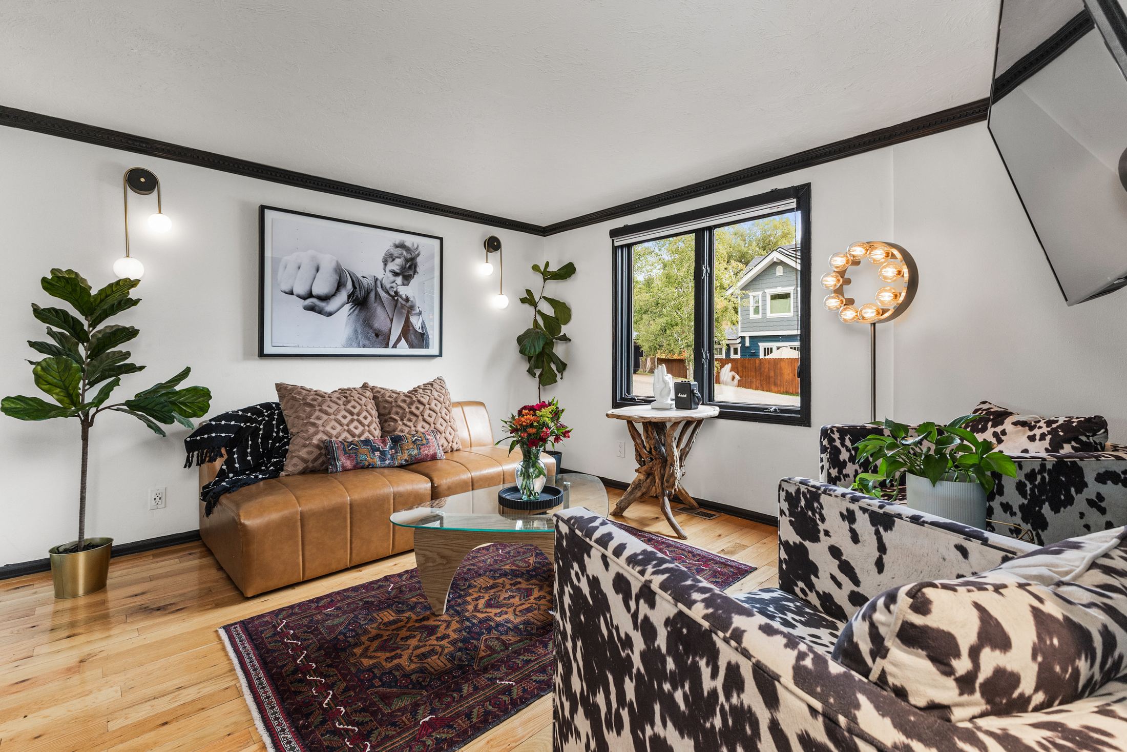 Lounge with cowhide-print chairs and vintage photography