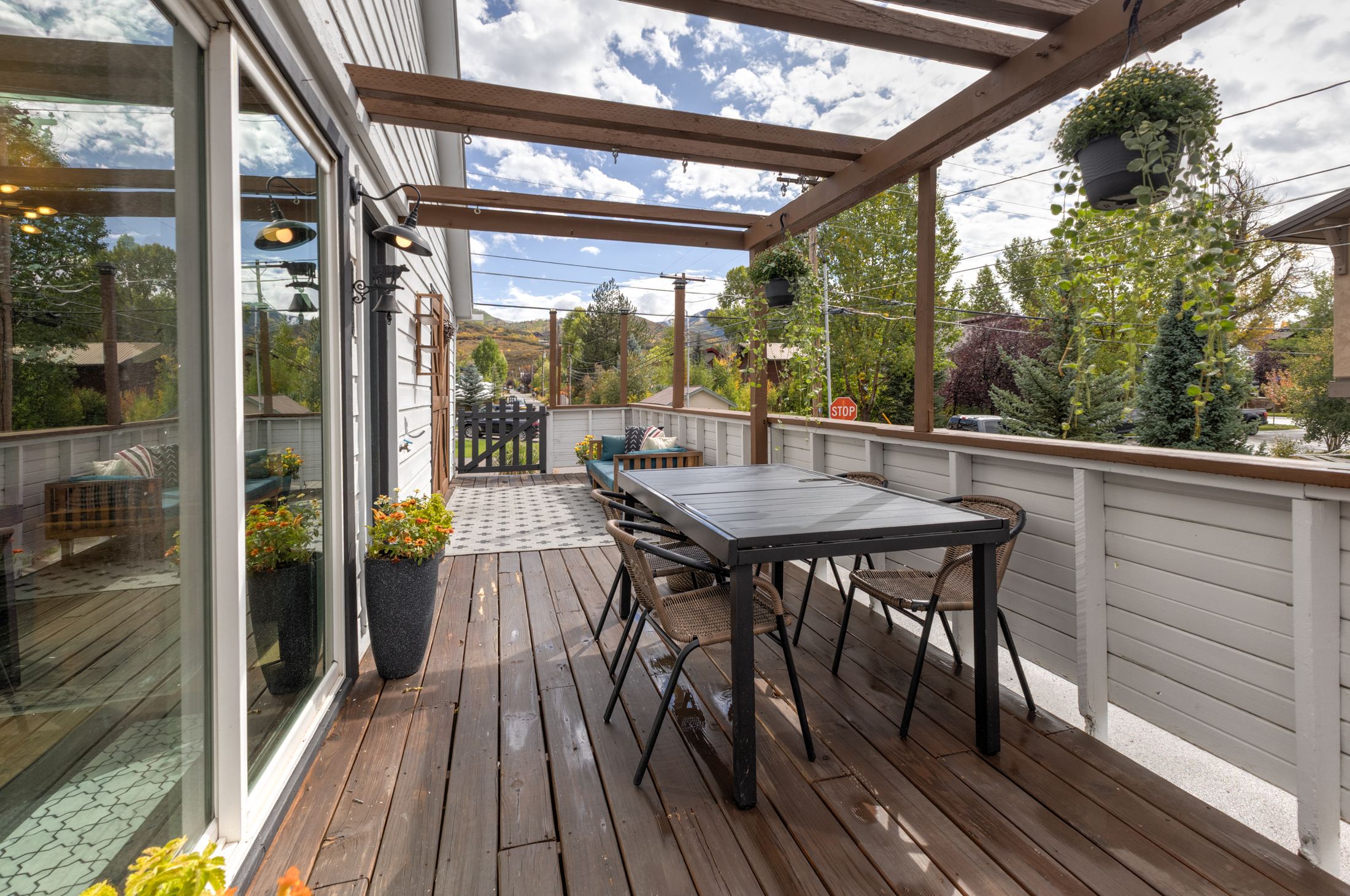 Pergola-covered deck with dining table